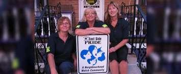 Marjorie Crew, along with fellow East Side Pride members, pose with a sign in 2011. (Photo via East Side Pride Facebook)