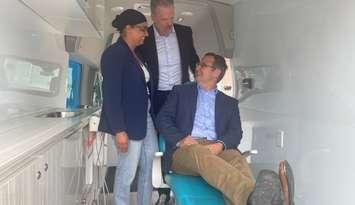 Minister Mark Holland and MP Irek Kusmierczyk inside the Smile Wagon with owner Navjeet Gill, June 25, 2024. 