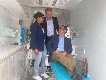 Minister Mark Holland and MP Irek Kusmierczyk inside the Smile Wagon with owner Navjeet Gill, June 25, 2024. 