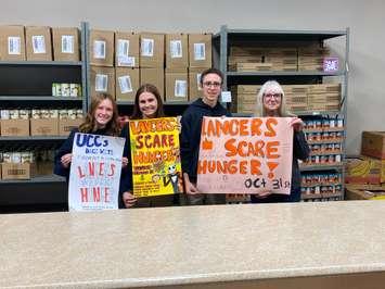 ‘Lancers Scare Hunger’ student organizers (L-R) Arwen Martin, Norah Lucier and Drew Rumble with Brenda LeClair, Executive Director of Chatham Outreach for Hunger. (Photo courtesy of the SCCDSB)