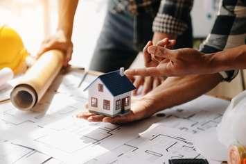 Discussion and planning of housing construction (Image by nuttapong punna / iStock / Getty Images Plus via Getty Images)