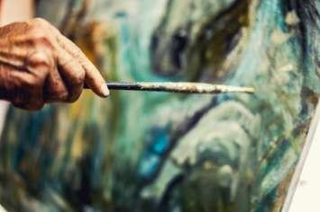 Artist painting on an easel (Image courtesy of MarijaRadovic /	iStock / Getty Images Plus via Getty Images) 