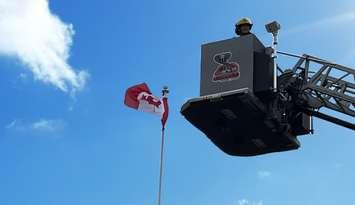 CK firefighter and Canadian flag (Image courtesy of Chatham-Kent Fire and Rescue)