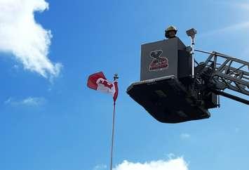 CK firefighter and Canadian flag (Image courtesy of Chatham-Kent Fire and Rescue)