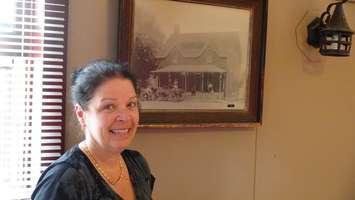 Montreal House owner Linda Defour, with a picture of the original building (Photo by Jake Kislinsky)