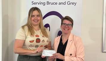 Danielle Bois,Community Relations and Fund Developer for the  Women’s House Serving Bruce and Grey, receives a $5,000 donation from Sarah Foster, Race  Director of the Lakeshore Triathlon, from this year’s race proceeds. Photo from Sarah Foster