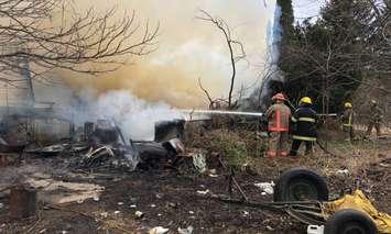 Firefighters battle a blaze at a property near Scane Rd. and Front Line south of Ridgetown. March 28, 2018. (Photo courtesy of Chatham-Kent Fire and Emergency Services via Twitter)