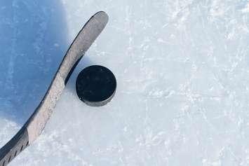 Hockey stick and a puck. © Can Stock Photo / bradcalkins