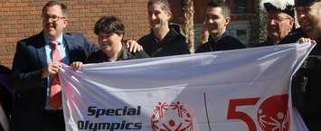Knights of Columbus members along with police and athletes hold the Special Olympics flag outside the Civic Centre in Chatham before it gets flown at the courthouse. March 25, 2019. (Photo by Greg Higgins)