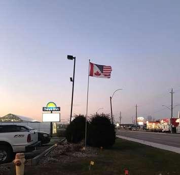 A half American, half Canadian flag in front of the Days Inn hotel in Wallaceburg. (Photo courtesy Ernie Taylor)
