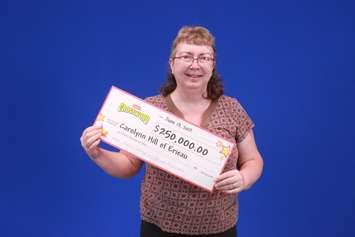 Carolynn Hill with her winnings. (Photo courtesy of OLG)