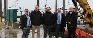 From left: Chatham-Kent councillor Anthony Ceccacci, Department of Fisheries and Oceans official Steve Newton, Senior Project Engineer Mike McDermott, Chatham-Kent Mayor Darrin Canniff, and Erieau Harbour Authority Corporation harbour manager Jeff Vidler pose for a photo at the Erieau Harbour. February 14, 2019. (Photo by Matt Weverink)
