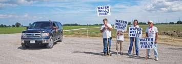 Water Wells First protesters stand at a wind turbine construction site north of Chatham. (Photo courtesy of Water Wells First)