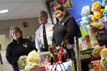 The Salvation Army's Beth Reave, Chatham-Kent Police Chief Gary Conn, and Salvation Army Captain Stephanie Watkinson  stand with toys donated from the CKPS, December 9, 2016 (Photo by Jake Kislinsky)