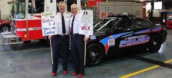 CK Fire and EMS Chief Ken Stuebing (left) and CK Police Chief Gary Conn wear red heels to support the Walk A Mile In Her Shoes event in Chatham. (Photo courtesy of the Chatham-Kent Women's Centre)