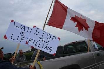 WWF protesters hang upside down Canadian flag on Bush Line in Dover Centre. August 29, 2017. (Photo by Sarah Cowan Blackburn News Chatham-Kent). 