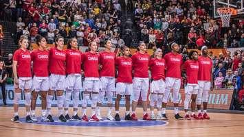 Bridget Carleton (third from left) stands with Canada's Women's Basketball ahead of a Tokyo Olympic qualifying game in Belgium. February 6, 2020. (Photo from @CanBball via Twitter)