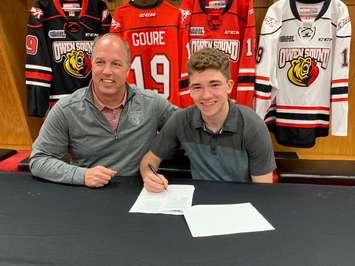 Attack sign Deni Goure to a standard player agreement. Photo courtesy of the Owen Sound Attack.