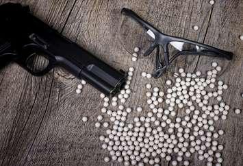Airsoft gun with glasses and lot of pellets. (© Can Stock Photo / philipimage)