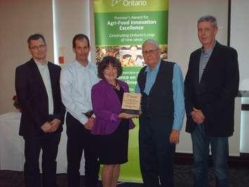 Representatives of Truly Green Farms accept an Agri-Food Innovation award, one of five handed out to Chatham-Kent and Essex farms, November 21, 2014. (Photo by Simon Crouch)