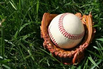 A baseball glove with a baseball. © Can Stock Photo Inc. / rmarmion