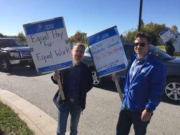 (Left to Right) Shahram Karimi; Professor & NSERC Industrial Research Chair Alternative Energy Engineering Technology  and Alan Warren; Coordinator of Mathematics and Physics picket at the entrance to Lambton College. October 18, 2017 (Photo by Melanie Irwin)