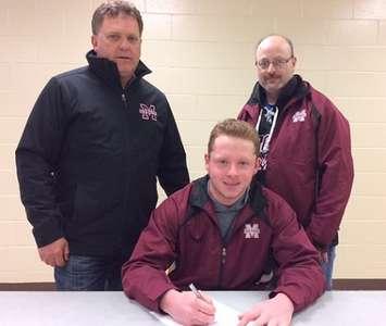 Nick Delyzer (centre) is joined by coach Ron Horvat (left) and GM Kevin Fisher (right) as he signs with the Chatham Maroons. (Photo courtesy of the Chatham Maroons)