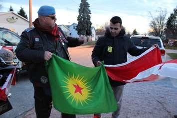 Kurdish and Canadian flags are exchanged as fallen veteran and Wheatley native John Gallagher's body is brought to the Blenheim Community Funeral Home on November 20, 2015. (Photo by Ricardo Veneza)