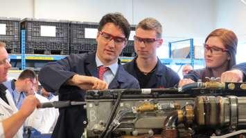 Prime Minister Justin Trudeau works on a heavy truck engine with students at Fanshawe College, April 14, 2016. Photo by Miranda Chant, Blackburn News.