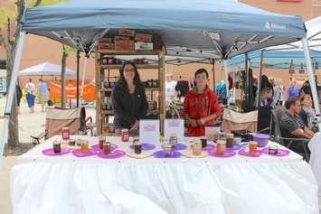 Local vendor Amy Roesch Dodman from Mrs. D’s sells her handmade jams and jellies with her son. (Photo courtesy of Moréna McDonald)
