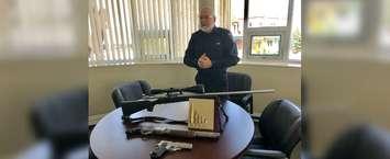 Chatham-Kent Police Constable Rob Tobin displays guns that were seized across the municipality in 2018. (Photo by Allanah Wills)