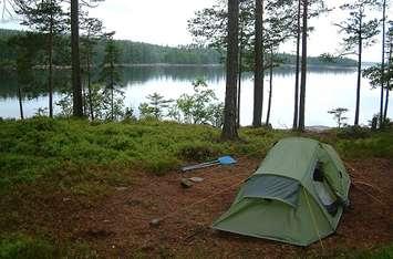A tent setup along the water. File photo courtesy of © Can Stock Photo / snip