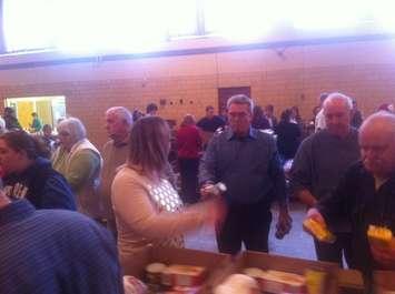 Volunteers pack food baskets for Chatham Goodfellows. (Photo by Mike James)