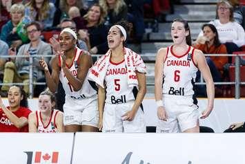 Bridget Carleton (far right) cheers on her teammates during a 2019 FIBA Olympic Pre-Qualifying Tournament in Edmonton. November 2019. (Photo courtesy of FIBA.)