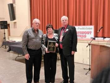 Dean and Barb Mills of  No Frills in Chatham receive the President’s Award from the President of Chatham Goodfellows Scott Williston, November 3, 2016. (Photo courtesy of Chatham Goodfellows)