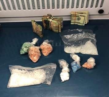 Drugs and cash seized from a residence on Longwoods Road in Chatham. April 15, 2021. (Photo courtesy of Chatham-Kent police)