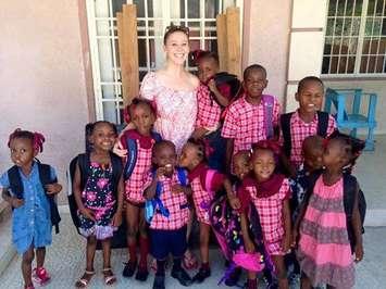 Chatham's Emily Hime poses for a photo with some of the children at Maison Ke Kontan as the get ready for school. October 19, 2015. (Photo courtesy of Emily Hime via Facebook)