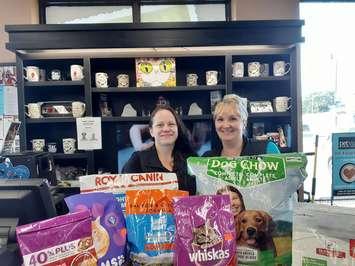 Pet Valu employees Beverlee Lachine and  Melissa Chenier donate food to animals in the Bahamas. (Photo courtesy Tanya Wilkie)