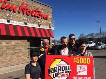 Alan Hudson of Chatham (middle) wins big in this year’s 'Roll Up the Rim to Win' contest at Tim Hortons. Mar 05, 2018. (Photo by Paul Pedro)