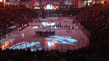 The Windsor Spitfires gather at centre ice during pregame ceremonies before their home opener, Thursday, September 24.  The Spitfires lost in overtime 4-3. (Photo by Mark Brown)