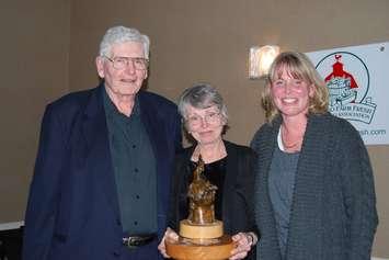 Bill and Diane Parks given  Lifetime Achievement Award from OFFMA representative Amy Strom (right) (Photo courtesy Parks Blueberries via Facebook) 