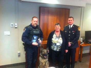 Bounty poses with Constable Larry Johnson, board chair Pat Belanger and chief Dennis Poole.