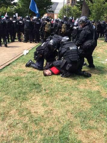 Police arrest a protestor in Charlottesville, Virginia on August 12, 2017. Photo courtesy of Virginia State Police/Twitter.