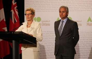 Premier Kathleen Wynne and Minister of Municipal Affairs Bill Mauro speak to media at the AMO Conference, August 15, 2016. (Photo by Maureen Revait) 