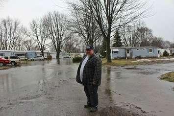 Todd Cadotte standing in front of flooding at St. Clair Community Estates in Chatham. February 20, 2018. (Photo by Sarah Cowan Blackburn News Chatham-Kent). 
