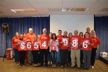 United Way employees stand with their grand total raised for United Way Chatham-Kent on November 19, 2015 (Photo courtesy of Union Gas).