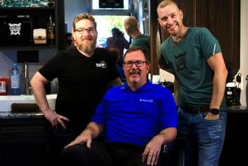 The Global Barber, Cedric Small is photographed alongside Chatham-Kent Mayor Darrin Caniff and Gregory Dennis, Owner of Black Comb Barber Shop in Blenheim, Ontario on Tuesday, October 19, 2021. (Photo by Millar Hill)