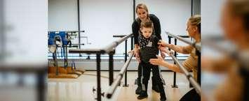 Bentley and mom Amanda Hann working with Physiotherapist Sarah Reed on the new set of parallel bars. November 8, 2019. (Photo courtesy of the CTC Foundation).