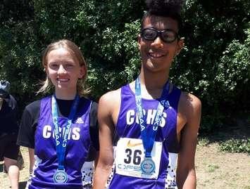 Julia VanMinnen (left) and Jeramiah Zomerman (right) show off their silver medals after competing at the OFSAA Track and Field Championships in Toronto. (Photo courtesy of Sharon Smith)