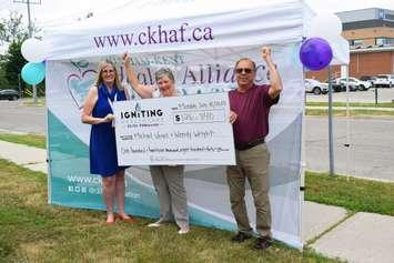 Mary Lou Crowley, President and CEO of CKHAF, presents a cheque for $126,840 Mike Veres and Wendy Wright, the winners of the 2022 Igniting Healthcare 50/50 FUNdraiser. (Photo courtesy of the CKHAF)